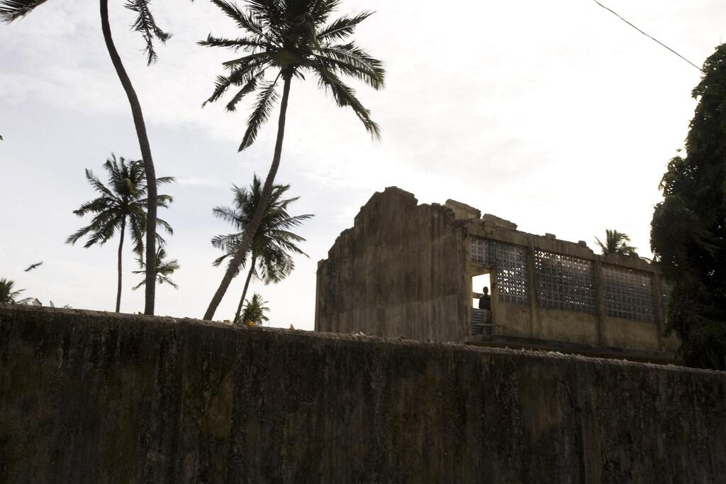 A 2007 photograph of a standing in a from a damaged, roofless structure in Sri Lanka's Jaffna district, which saw some of the most brutal fighting during the civil war.